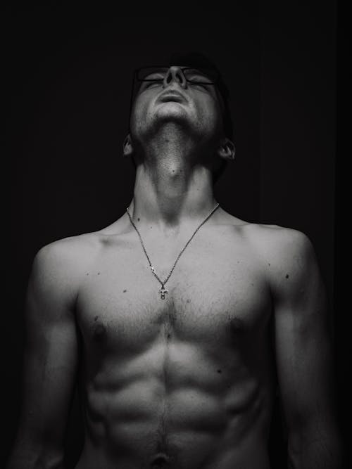 Black and White Photo of a Shirtless Man
