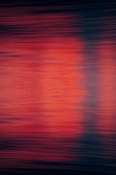 Abstract image featuring blurred red and blue colors resembling water reflections, creating a dynamic and artistic look.