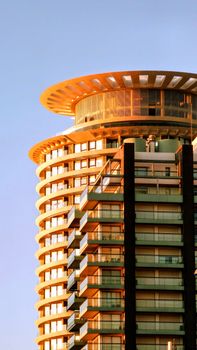 Stunning view of a modern skyscraper with futuristic design elements and glass facade.