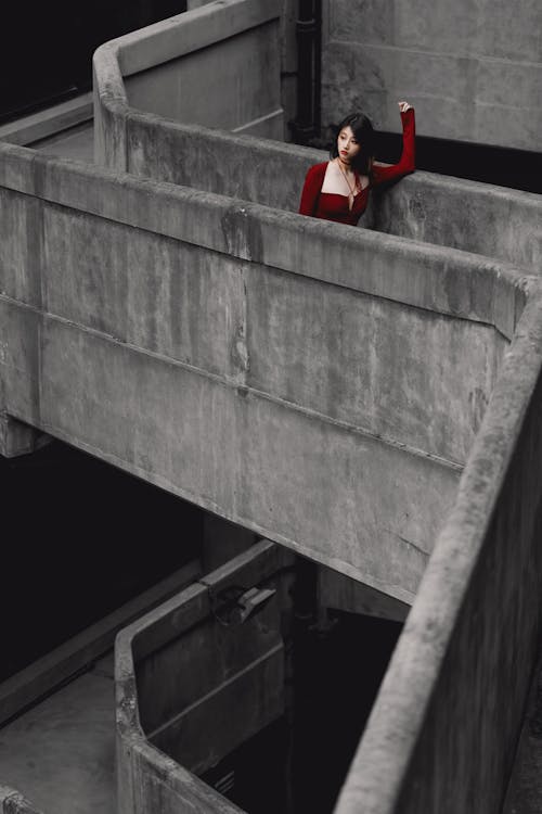 Woman Standing on Concrete Staircase