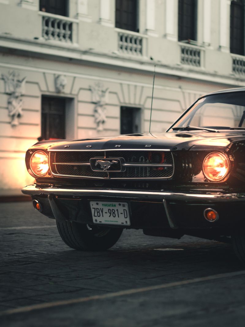 Front grille of a classic Ford Mustang at dusk
