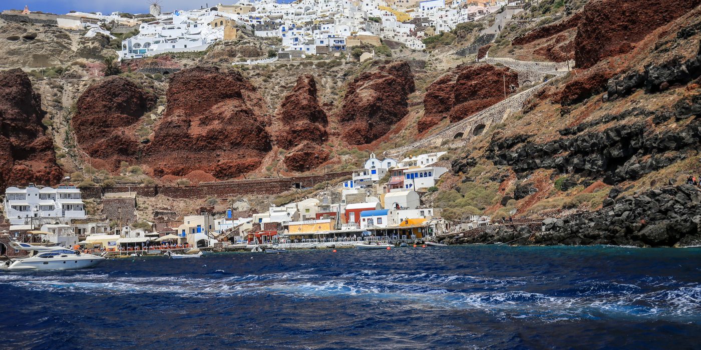 Whitewashed houses on a Greek hillside above the sea