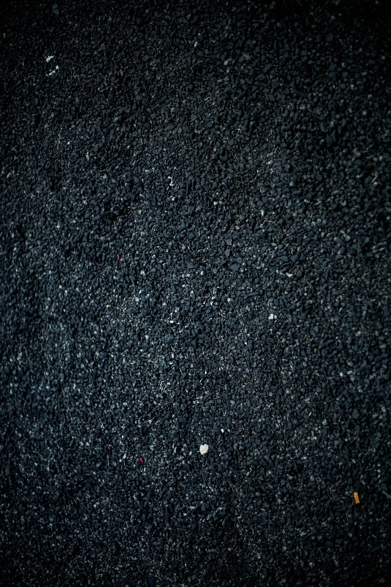 Close-up of dark asphalt aggregate texture