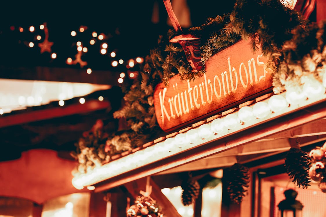 A Signage Surrounded with Pine Needles 