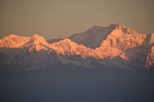 Free Beautiful snow-covered Himalayan mountains illuminated by the sunrise golden light. Stock Photo