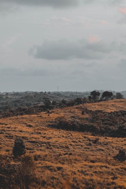 A tranquil scene featuring rolling hills under a cloudy sky, ideal for nature enthusiasts.
