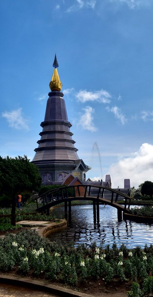 Free Serene view of a stunning pagoda with gardens and a bridge in Doi Inthanon National Park, Thailand. Stock Photo