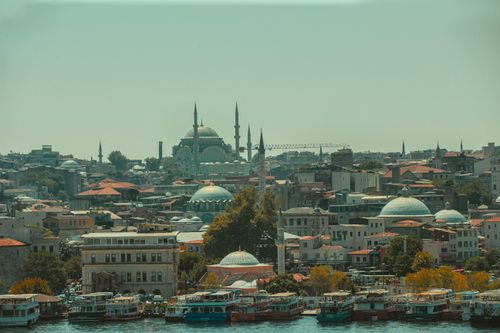 Free Explore the enchanting skyline of Istanbul featuring iconic mosques and bustling waterways with colorful boats. Stock Photo