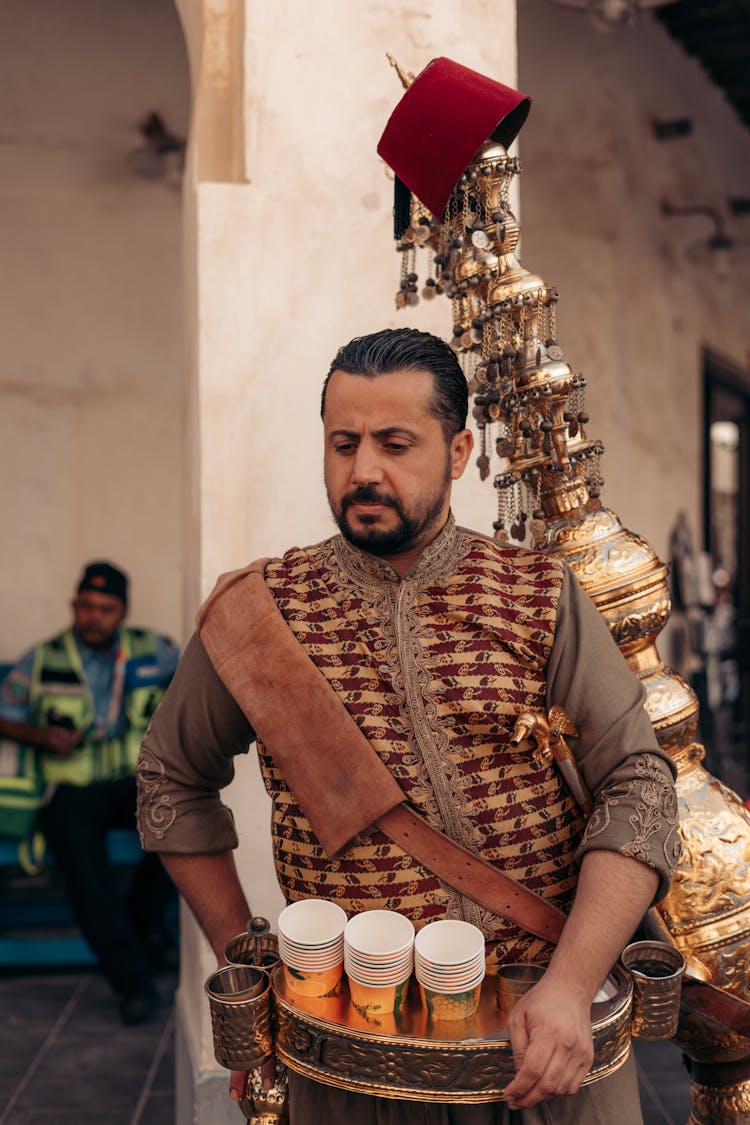 Man In Traditional Wear Selling Coffee 