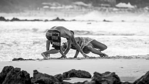 Man and Woman Playing on Seashore