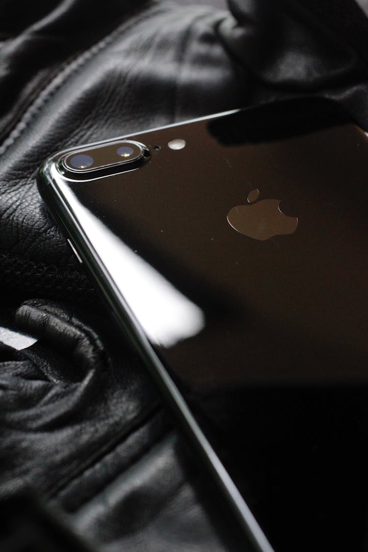 A Black Iphone In Close-Up Photography