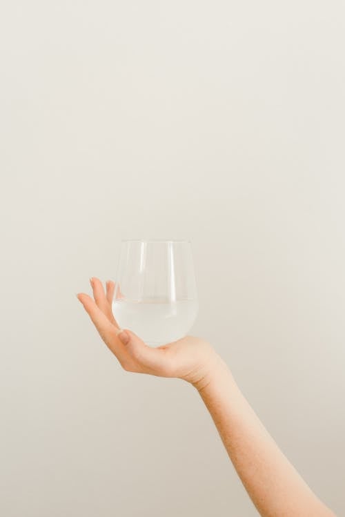 A Hand Holding a Glass 