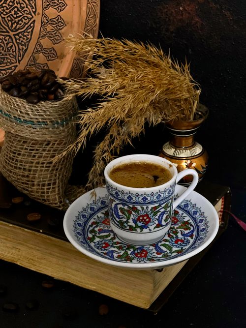 Free A traditional Turkish coffee in an ornate cup with rustic decor, coffee beans, and adornments. Stock Photo