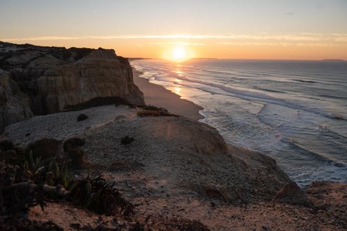 Free Breathtaking sunset view over the cliffs and ocean in Nazaré, Portugal, showcasing natural beauty. Stock Photo