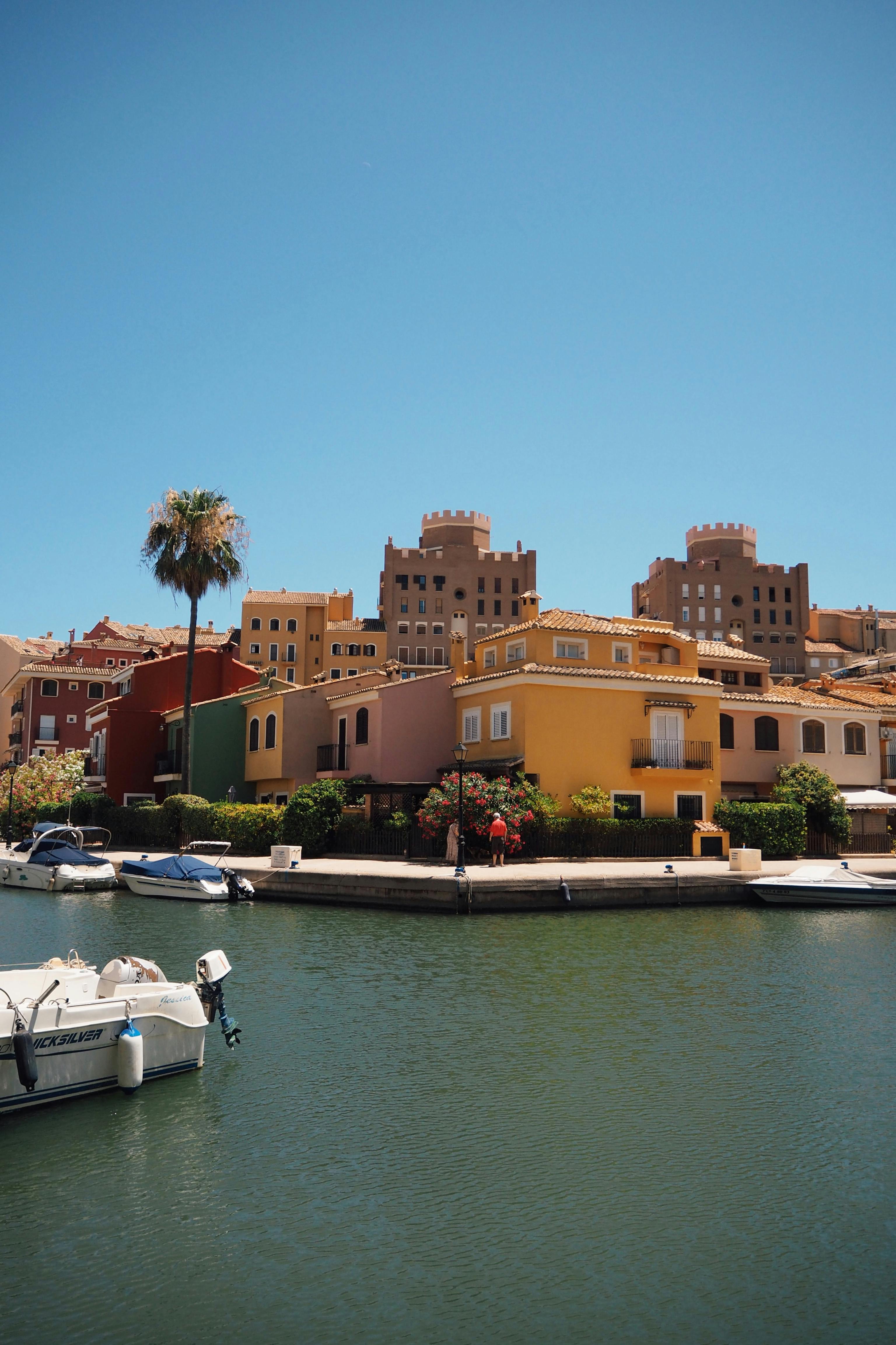 Scenic view of colorful buildings and waterfront in Port Saplaya, Valencia, Spain.