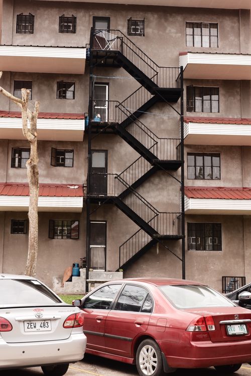 Free A multi-story apartment building with parked cars in Silang, Philippines. Stock Photo