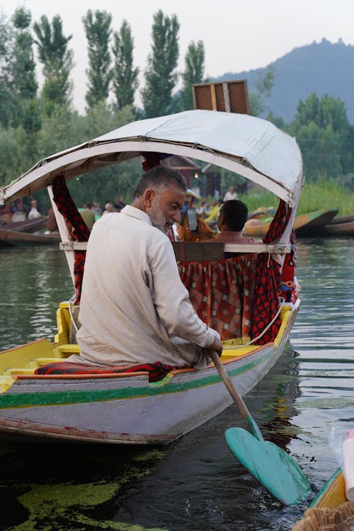 Boatman Transporting People through River