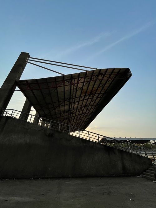 Free Concrete stadium bleachers and metal roof captured at twilight under a clear sky. Stock Photo