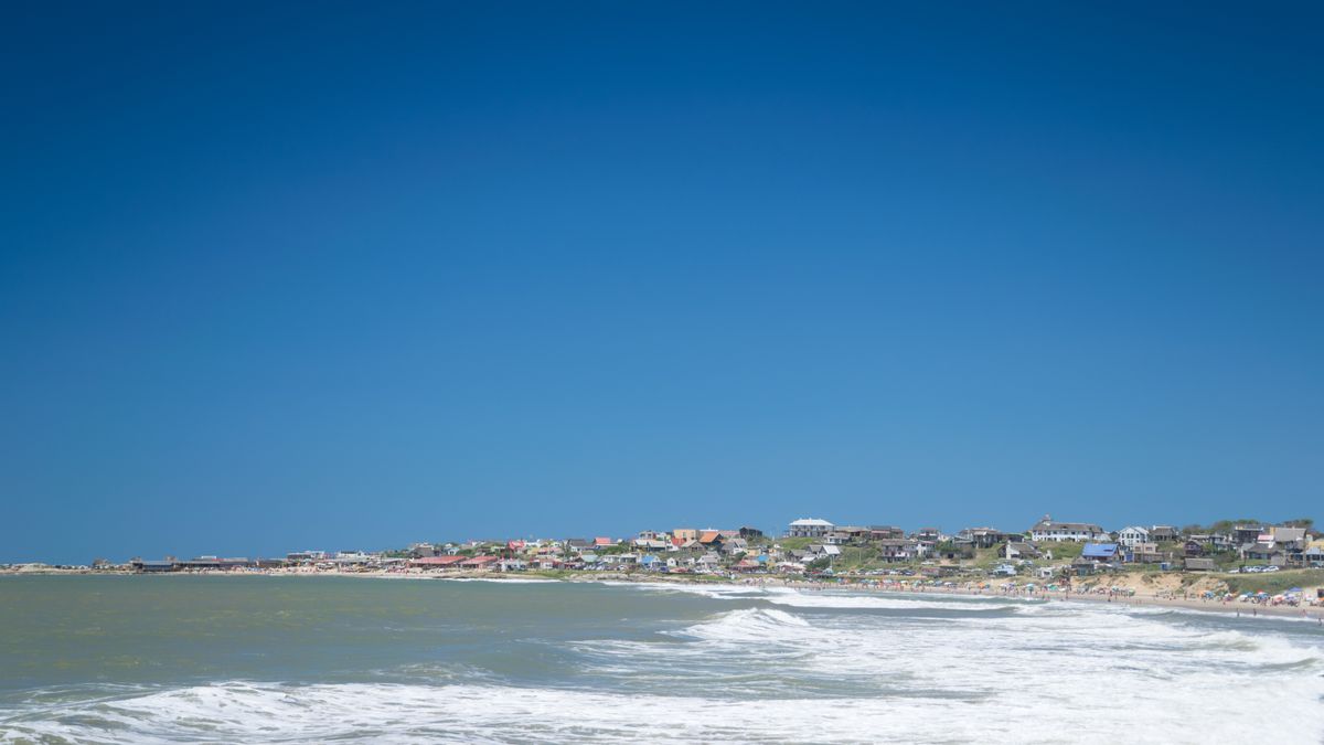 Beach, waves and village houses at Punta del Diablo, Uruguay