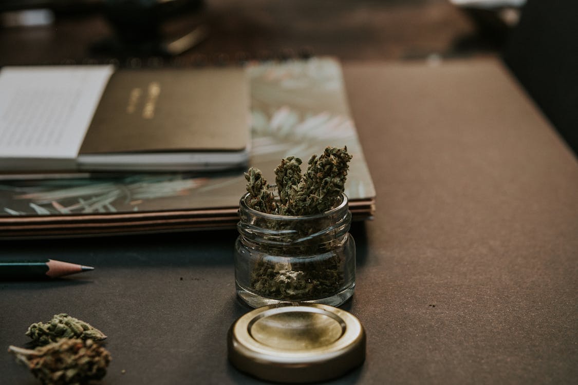 Free Close-Up Photo of Kush On Glass Container Stock Photo