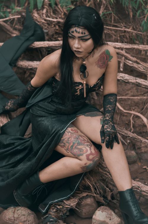 Free Striking pose of a gothic fashion model outdoors, showcasing tattoos and a stylish black outfit. Stock Photo