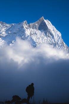 Silhouette of a climber against Machapuchare in the Annapurna mountains, Nepal.