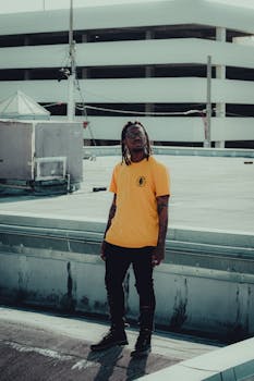 A stylish portrait of a man on a rooftop in Orlando, showcasing urban fashion and vibe.