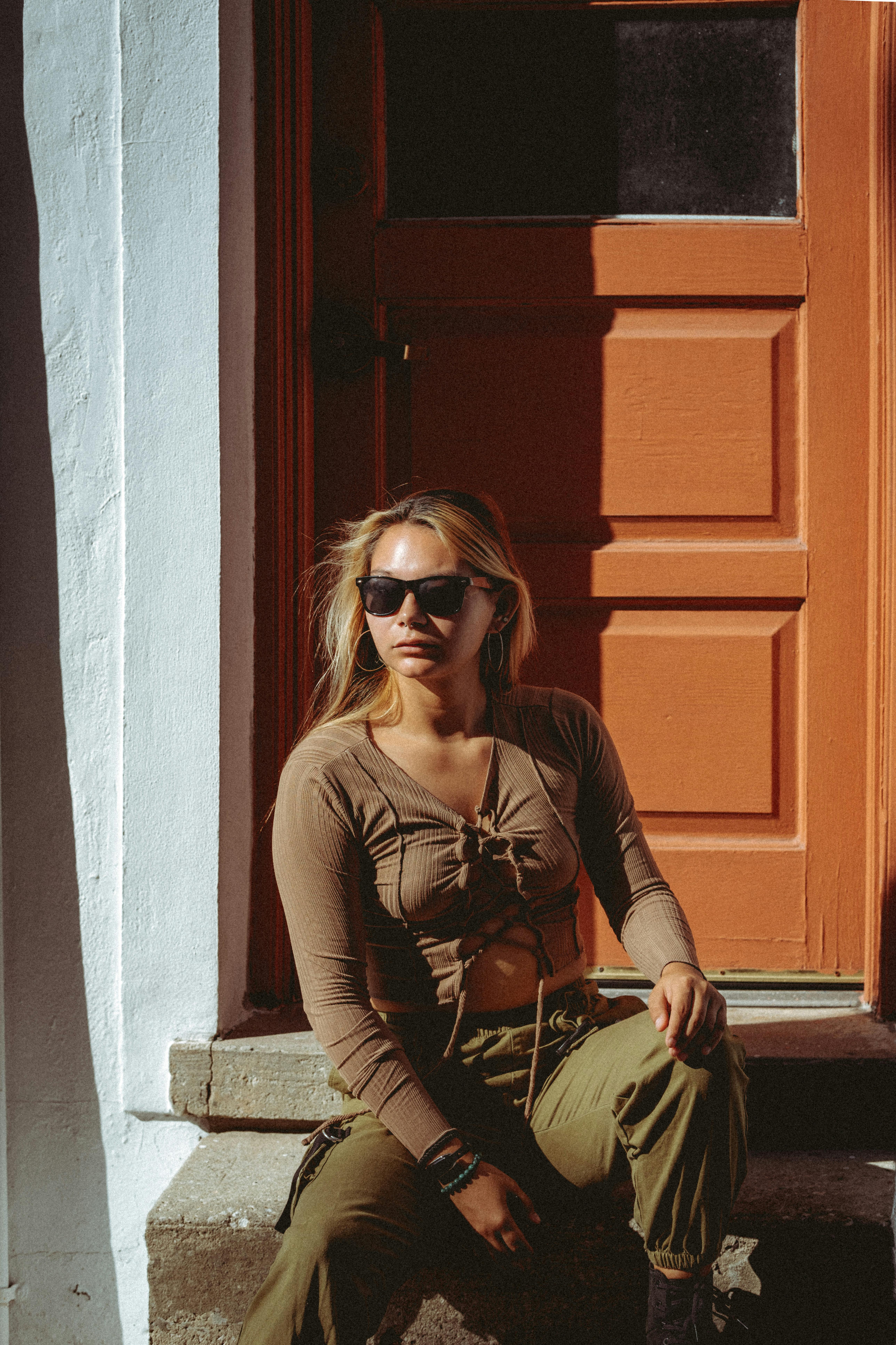 a woman sitting on the steps of a building