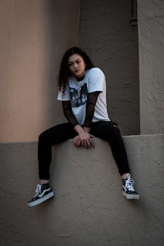 Stylish young woman poses against an urban backdrop in Orlando, FL, showcasing modern fashion.