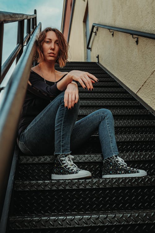 A Woman Sitting on Stairs