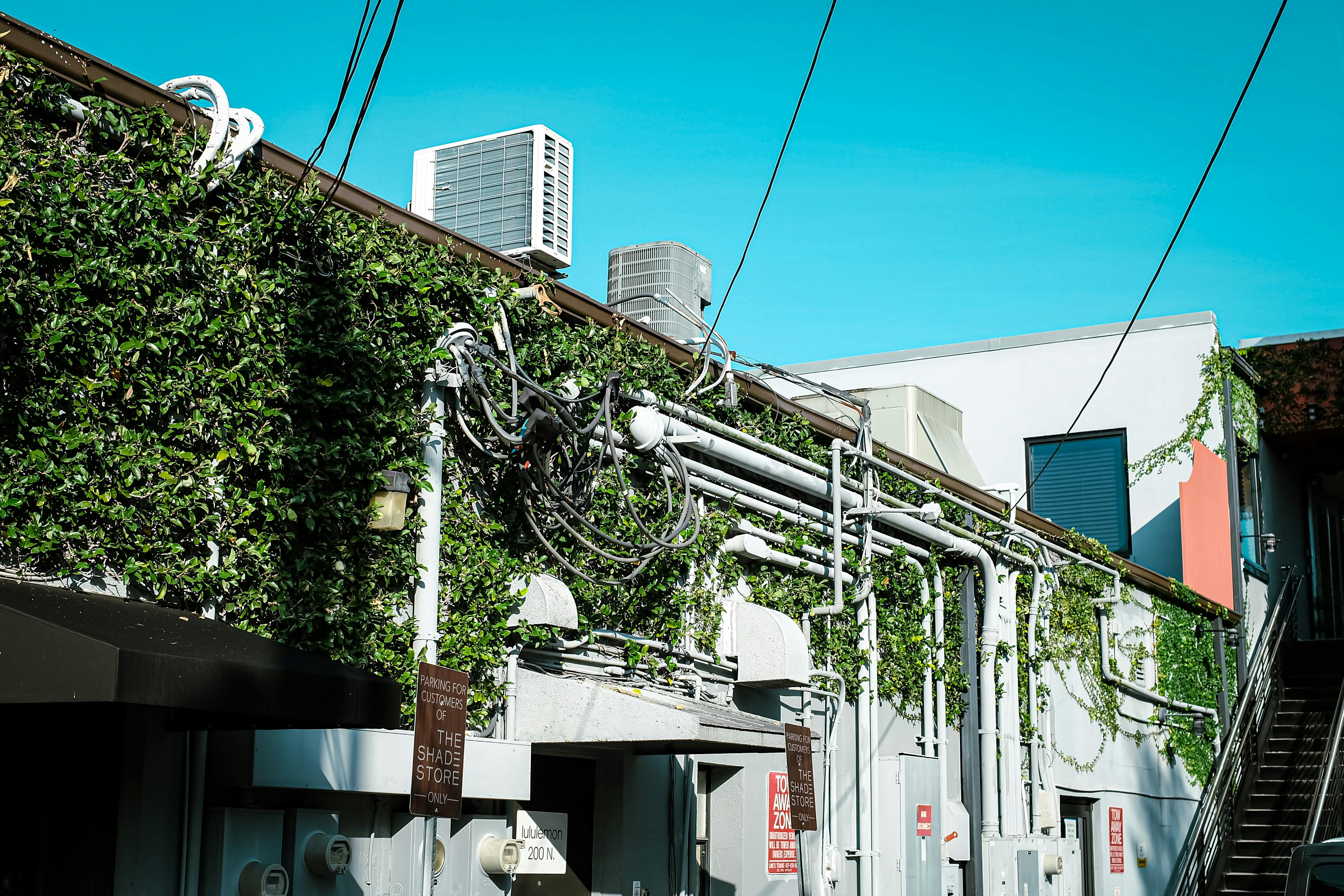 a building with a green roof and a white wall