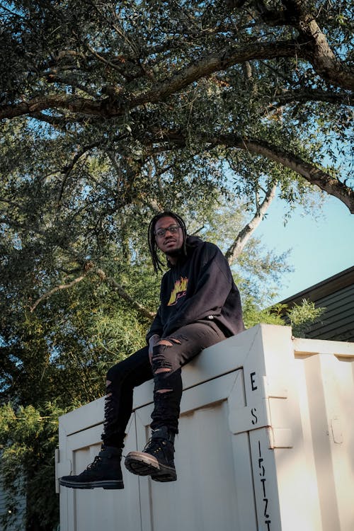 A Man in Black Hoodie Looking at the Camera