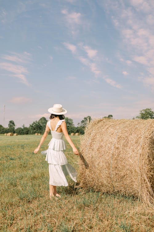 Woman by Hay Bale in Summer