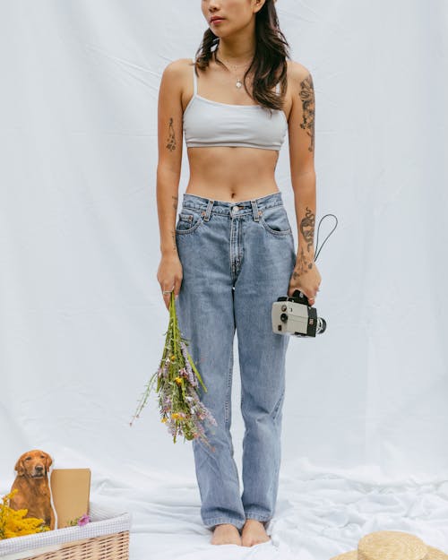 A Woman in White Sports Bra and Blue Denim Jeans