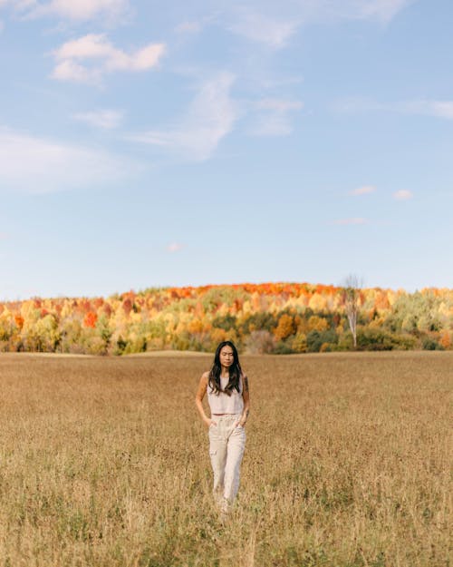 Model Posing in Blouse and Pants against Autumn Forest