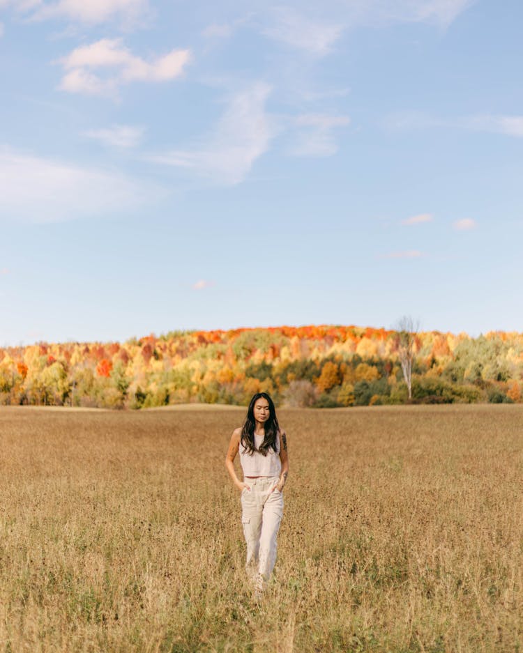 Model Posing In Blouse And Pants Against Autumn Forest