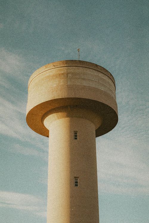 Free Water tower in Arganil, Portugal, under a clear blue sky. Architectural marvel with serene backdrop. Stock Photo