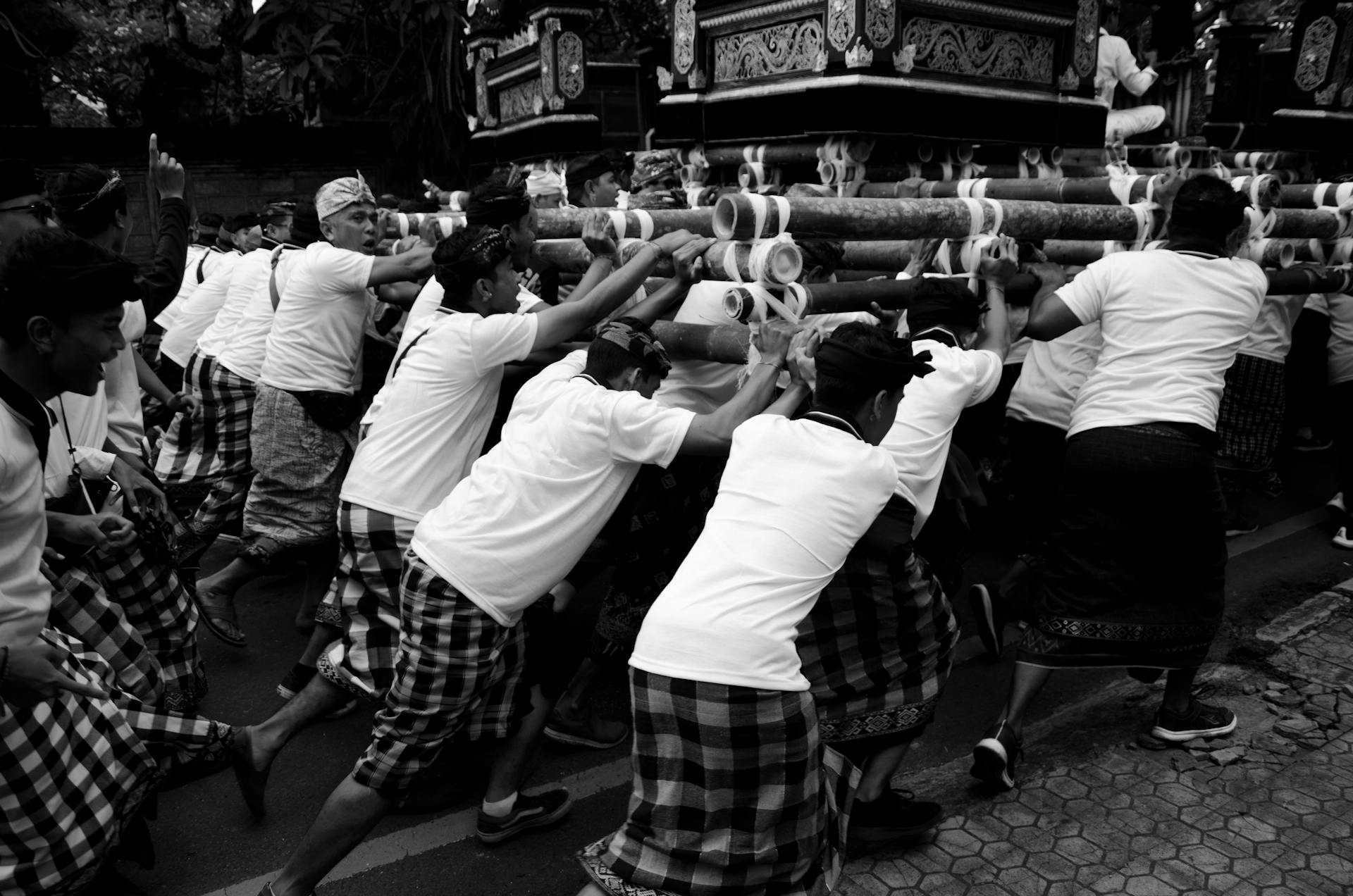 Black and white capture of a traditional Balinese funeral procession in Gianyar, showcasing cultural rituals and community.