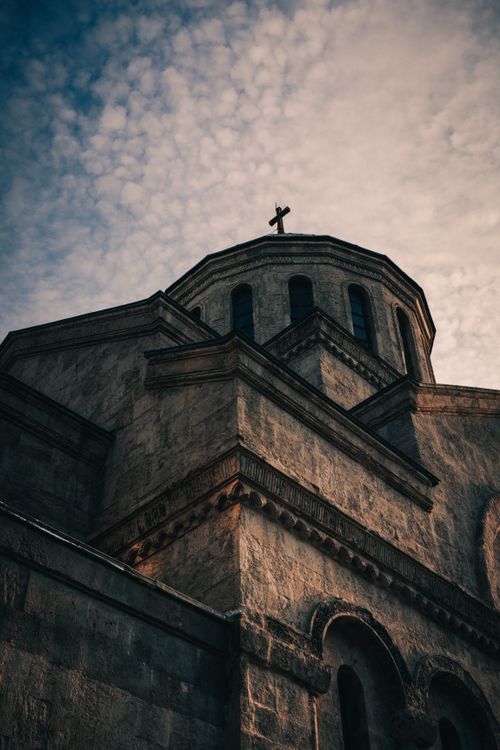 Free Low angle view of an ancient church facade in Istanbul, capturing its architectural beauty against a cloudy sky. Stock Photo