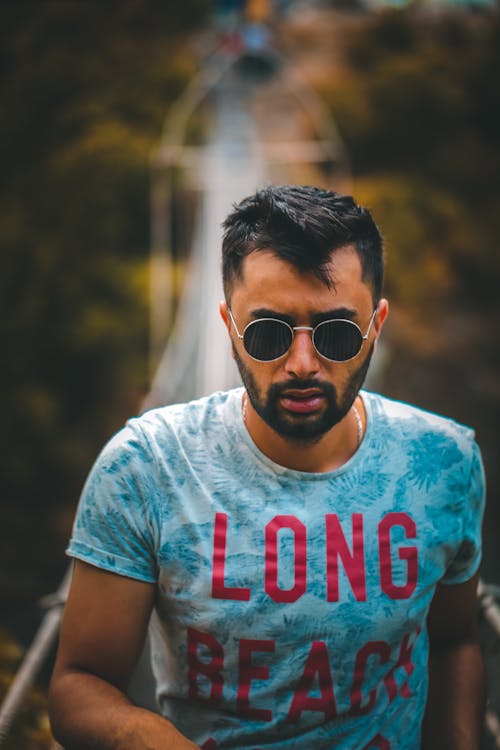 Close-Up Photo of Man Wearing Round Sunglasses