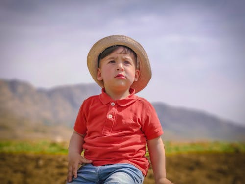 A Boy in a Polo Shirt Wearing a Hat 