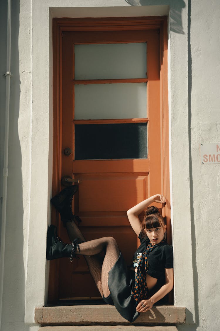 Young Woman Sitting In The Doorway 