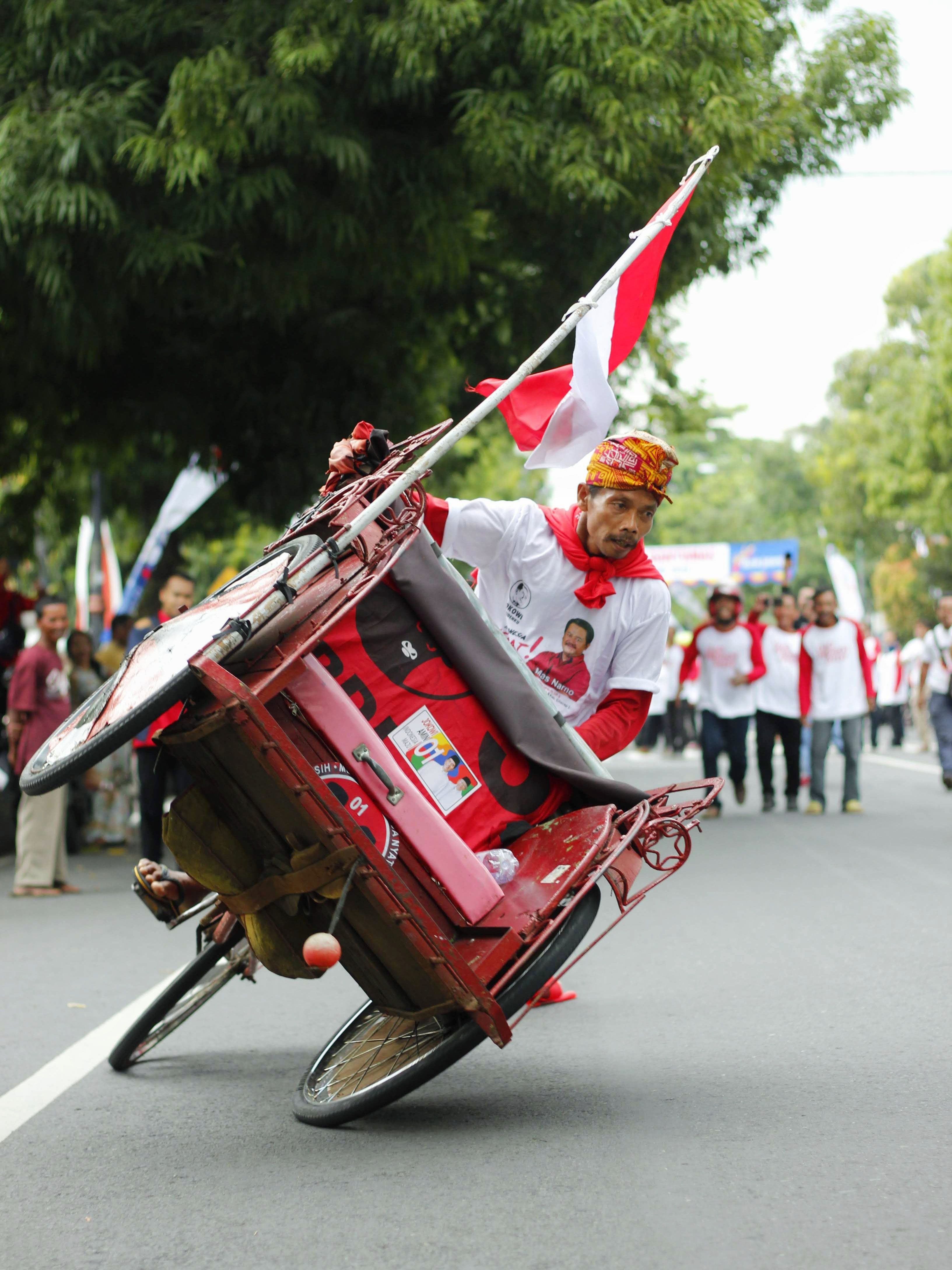 Man Riding in a Rickshaw on a Street during a Parade · Free Stock Photo