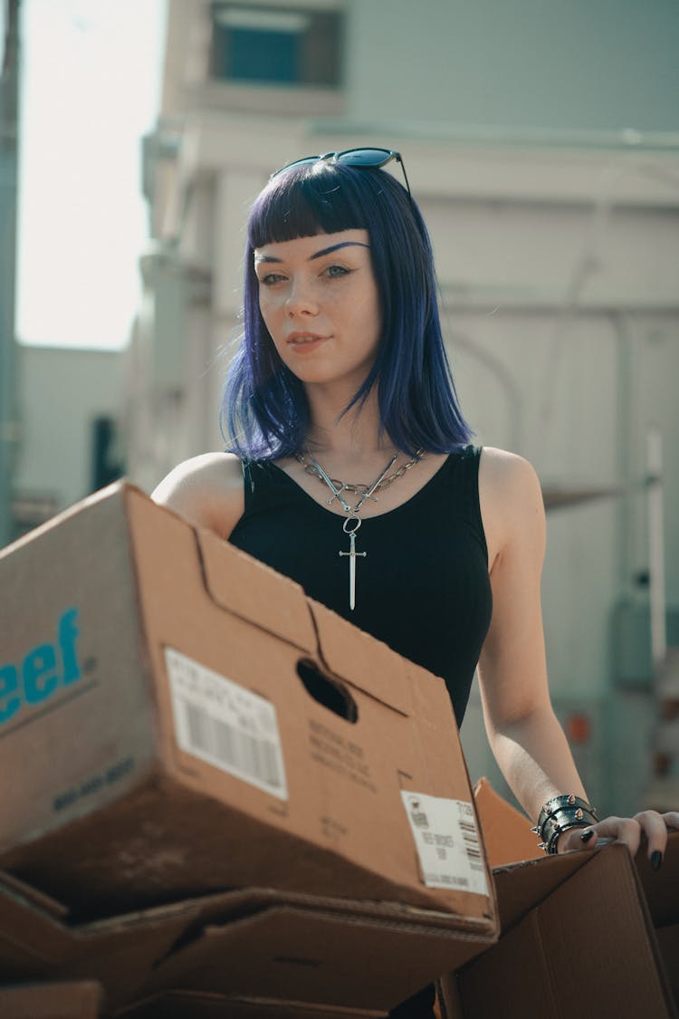 Young Woman Holding A Cardboard Box 