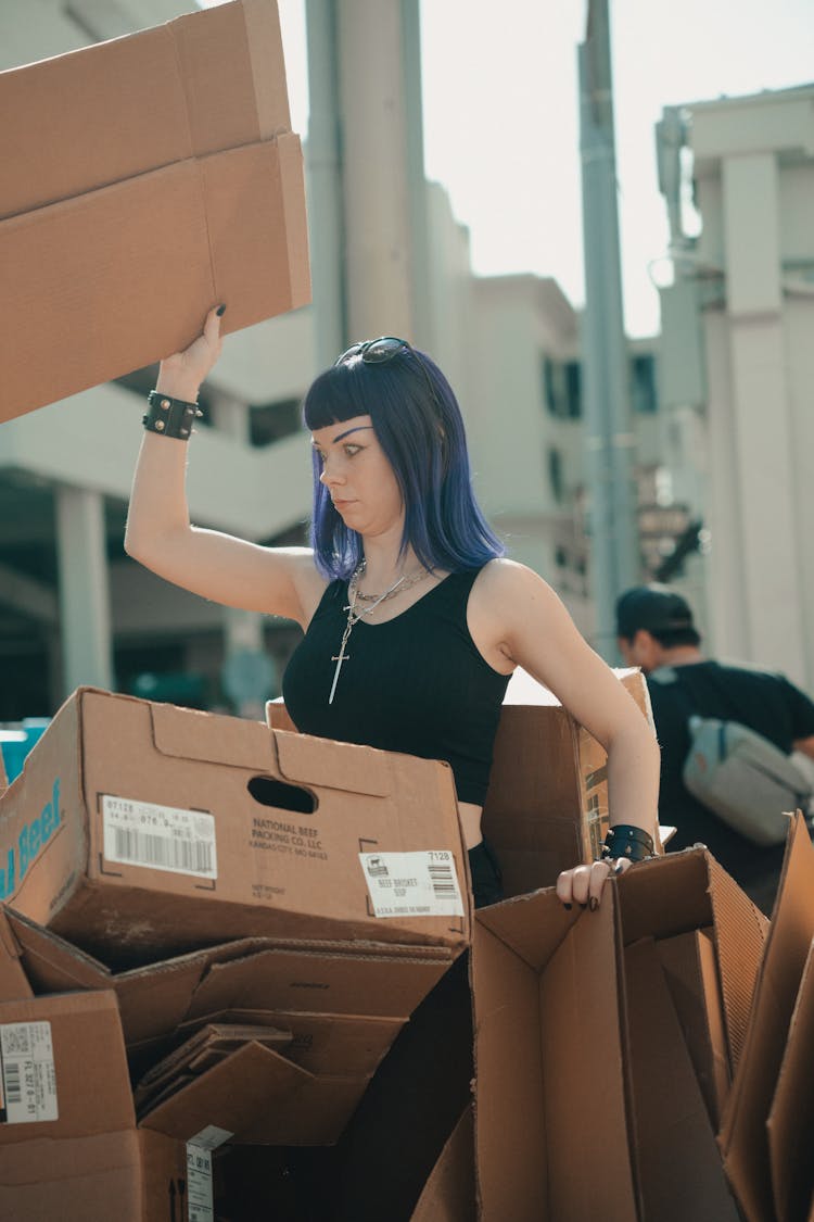 Woman Surrounded With Cardboard Boxes