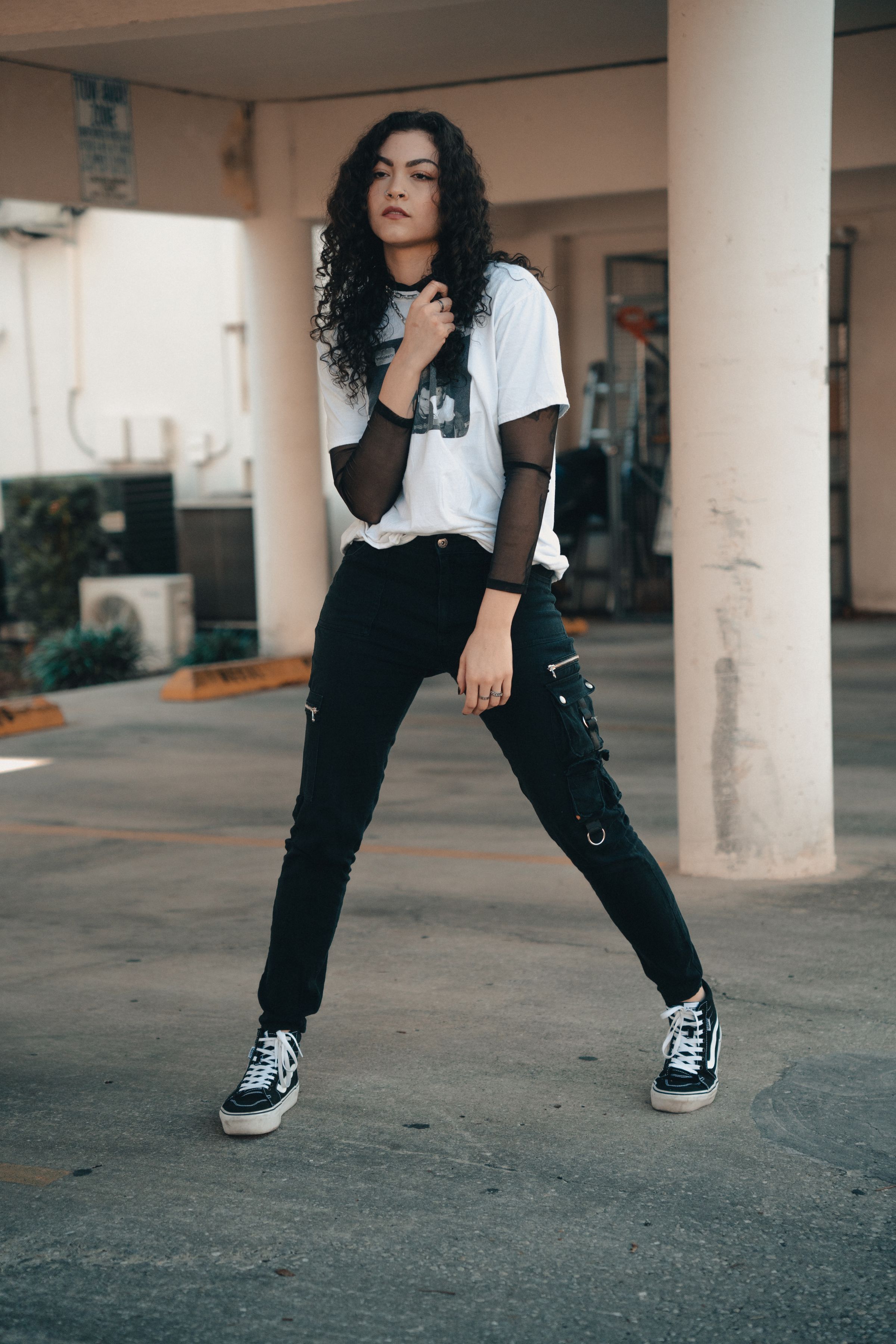 Young woman in casual streetwear walking outdoors in mild weather