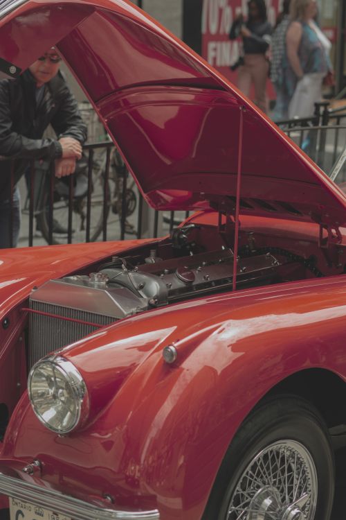 Free Vintage red car with an open hood displayed outdoors in Toronto, Canada. Stock Photo