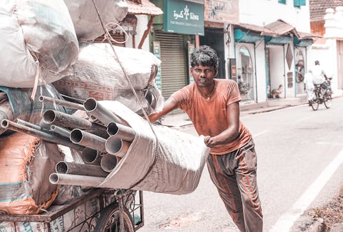 Man Holding White Sack Filled With Pipes