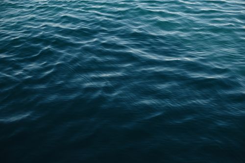 Free Close-up view of gentle ocean waves with a serene and tranquil atmosphere. Stock Photo