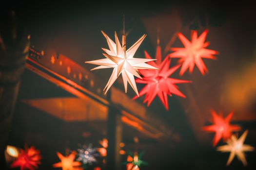 Close-up of illuminated star decorations, creating a warm festive ambiance.